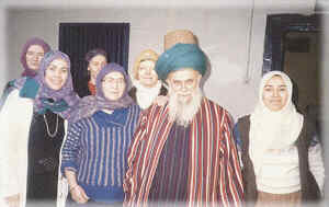 Shaykh Nazim with his wife and two daughters (front) at their home in Cyprus. As a shaykh of the Mevlevi Order Shaykh Nazim is wearing the traditional turban that is its trademark, wrapped on the tall Mevlevi sikke.
